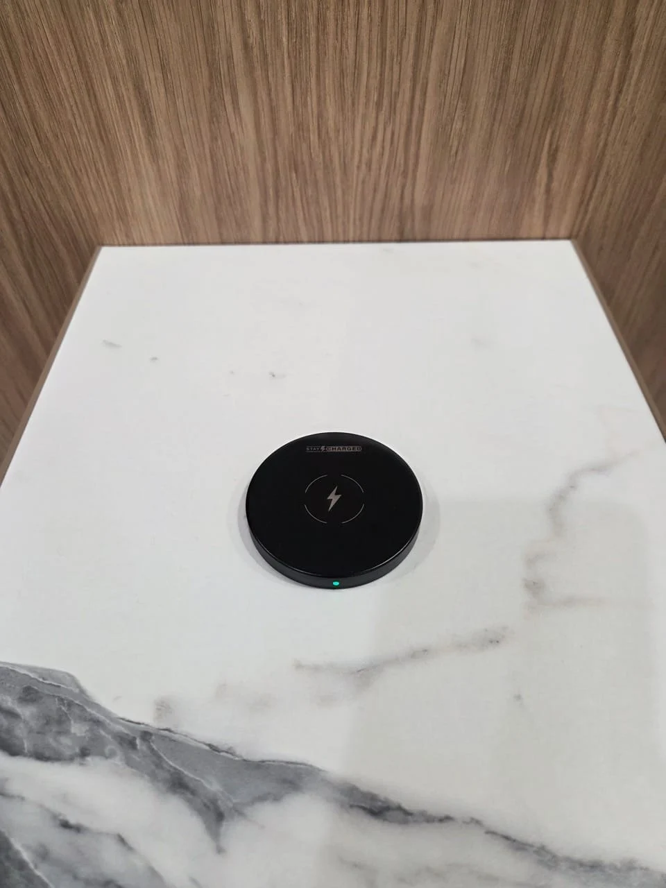 SwiftPro charger set into a white stone meeting table