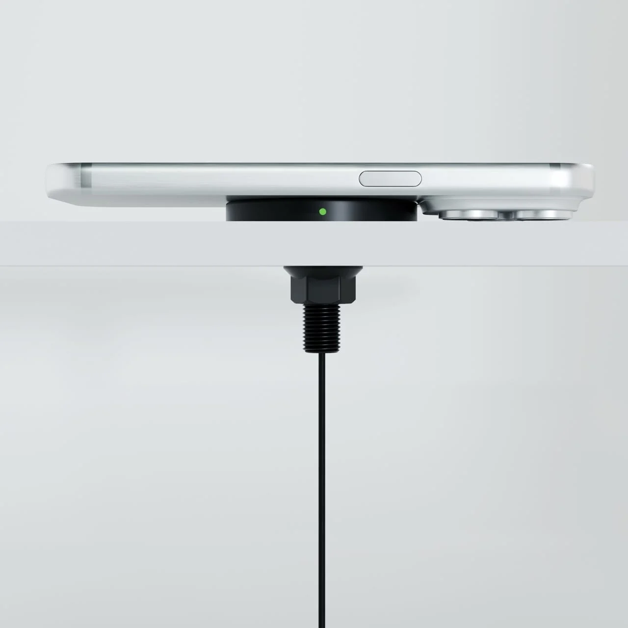 Side view of a phone on a SwiftPro charger: the raised pad clears the camera bump