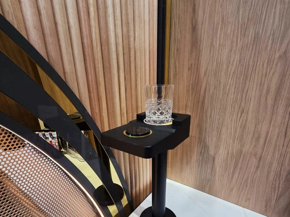 ChargeHUB holding a glass beside venue seating
